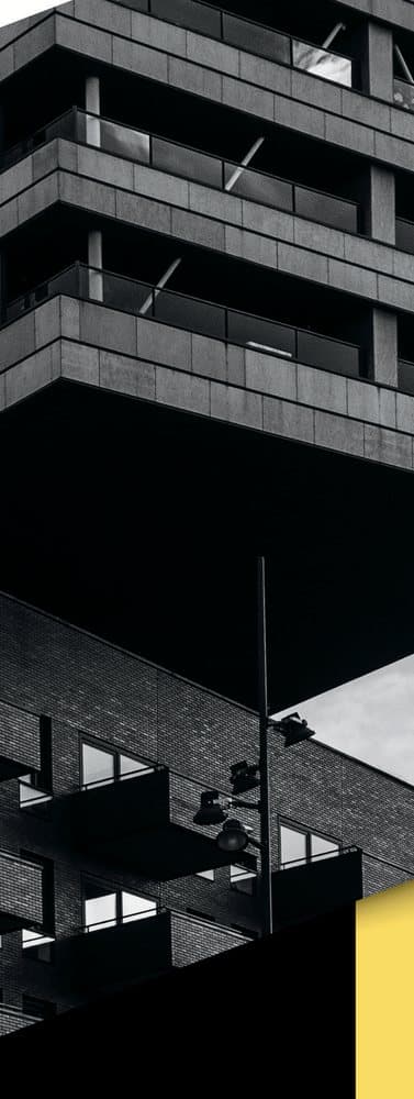 Black and white modern apartment building with cantilevered balconies