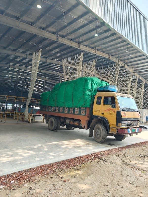 Loaded truck inside steel warehouse frame