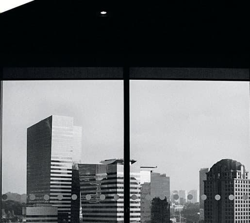 City skyline seen through a dark office window